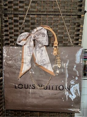 Louis Vuitton Elegant Brown Shopping Tote Bag with Scarf Accent and charms